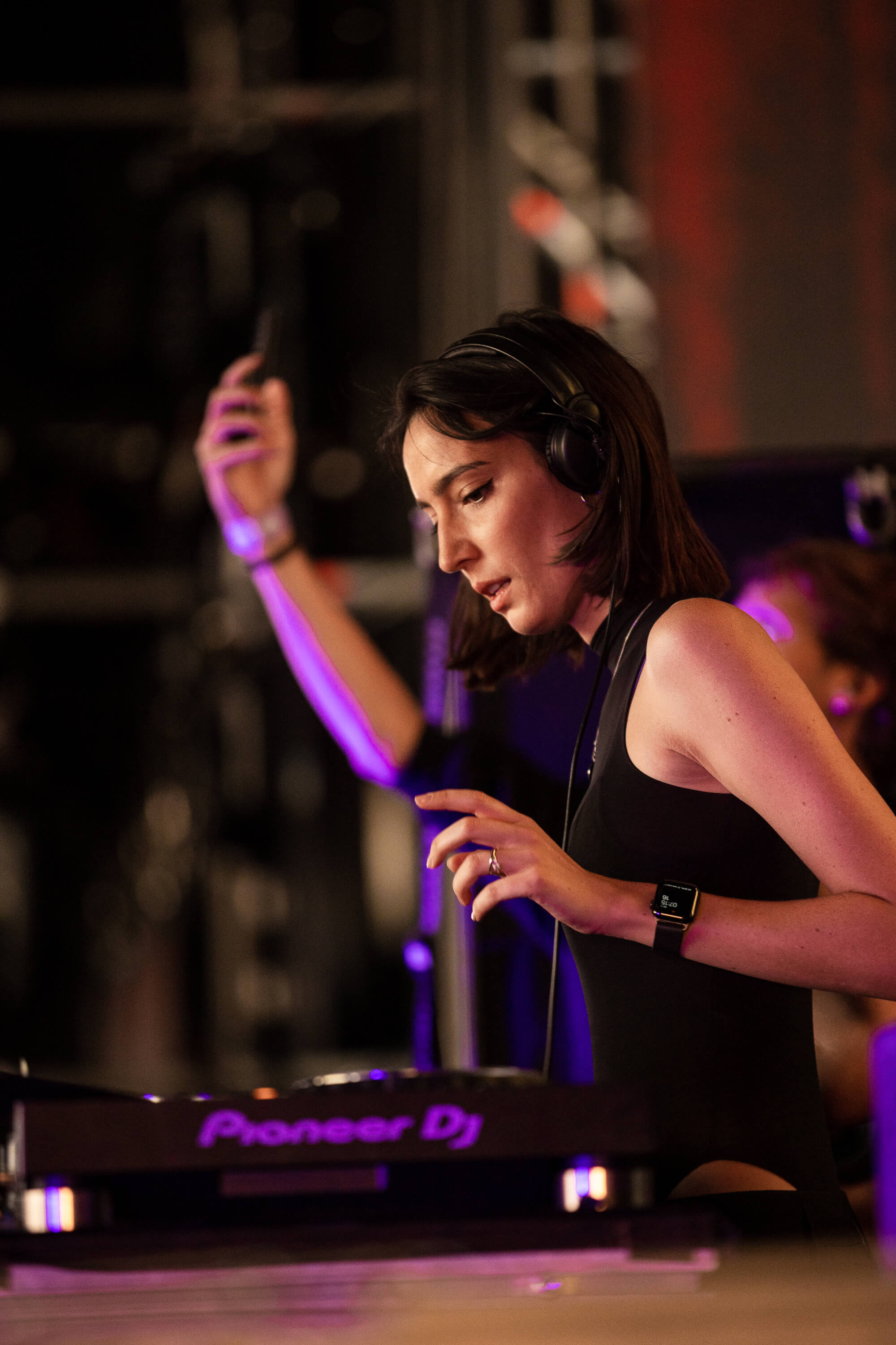 Professional DJ performing with turntables and mixing equipment